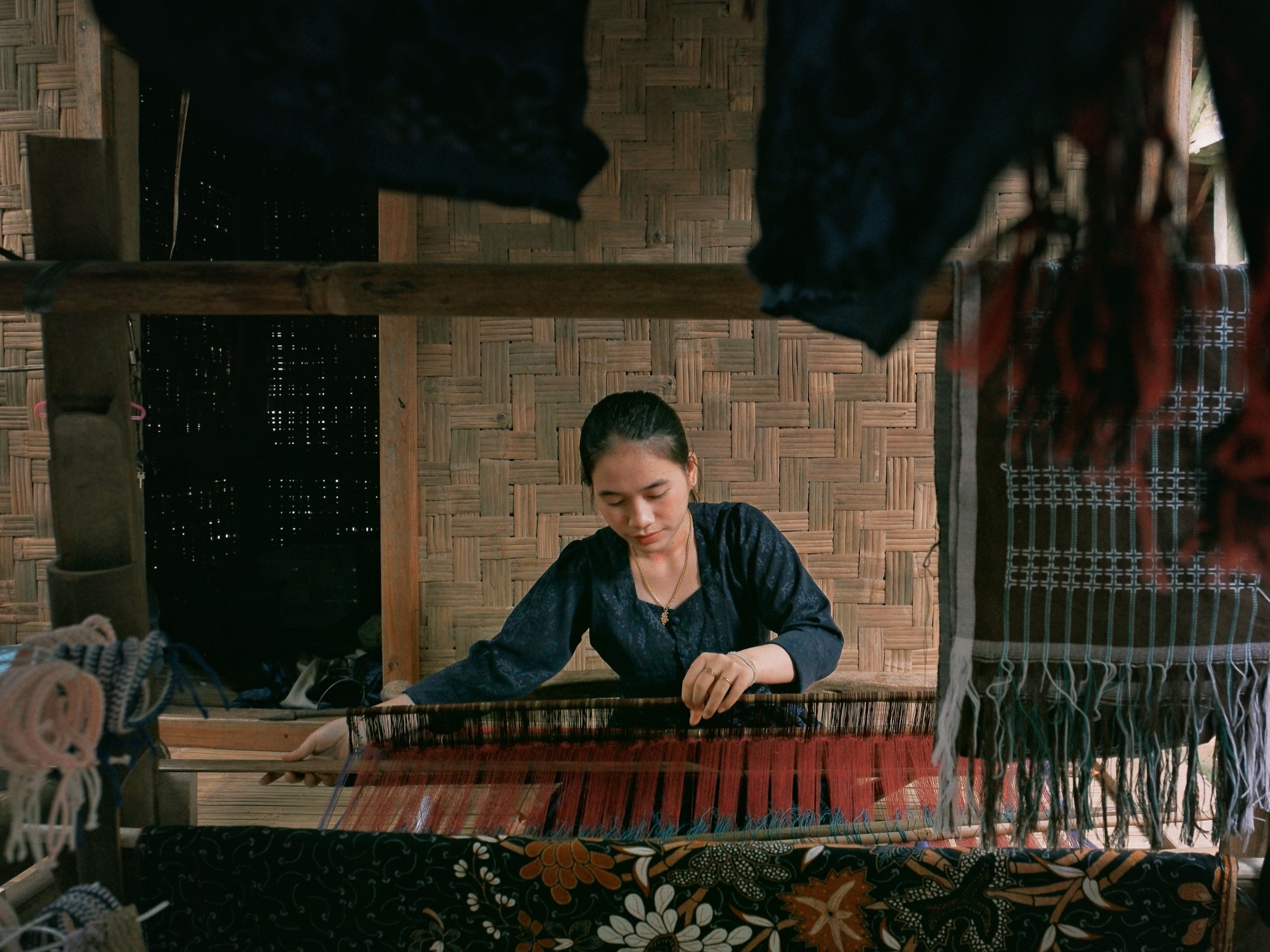 Weaver at the loom crafting Rangrang ikat cloth